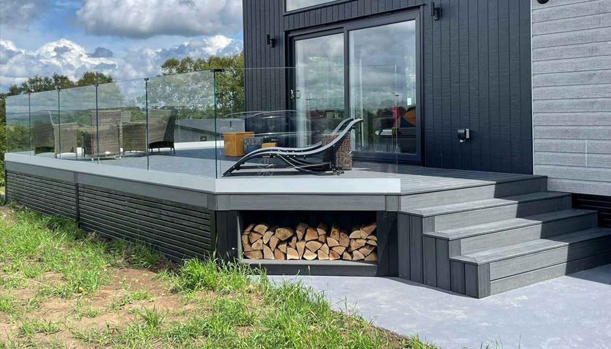 TREX Enhance Naturals Calm Water Decking with bespoke log store and contemporary style slatted skirting around the base completed in Harrogate