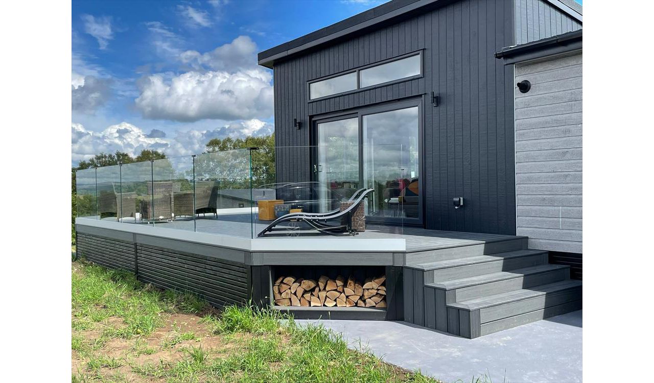 TREX Enhance Naturals Calm Water Decking with bespoke log store and contemporary style slatted skirting around the base completed in Harrogate
