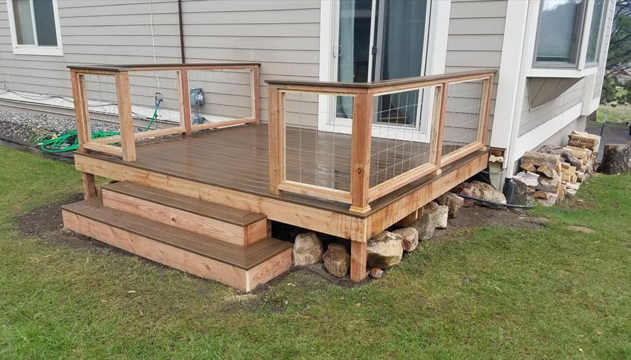 Brosseau Deck, Big Sky, MT. Project completion with wood frame/wire mesh railing and trex rail cap.