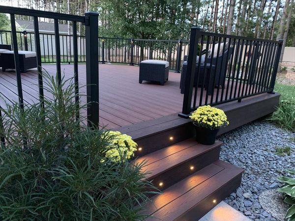 Spice up your outdoor living space with LED Trex lighting. Trex Transcend Fire Pit and Vintage Lantern with Trex Signature Black Aluminum Railing.
