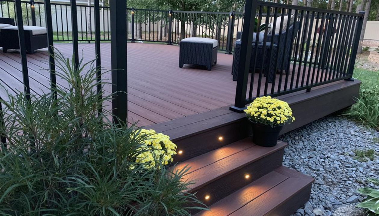 Spice up your outdoor living space with LED Trex lighting. Trex Transcend Fire Pit and Vintage Lantern with Trex Signature Black Aluminum Railing.