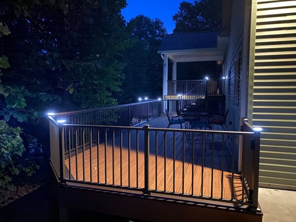 Two-Tone, Picture-Framed, Low-Maintenance Trex Transcend Composite Deck with Black, Aluminum Railing and LED Lighting for Safety and Ambiance in the Rochester, MN Area built by Schmidt Carpentry, LLC