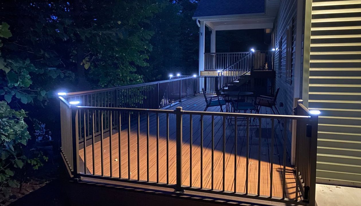 Two-Tone, Picture-Framed, Low-Maintenance Trex Transcend Composite Deck with Black, Aluminum Railing and LED Lighting for Safety and Ambiance in the Rochester, MN Area built by Schmidt Carpentry, LLC