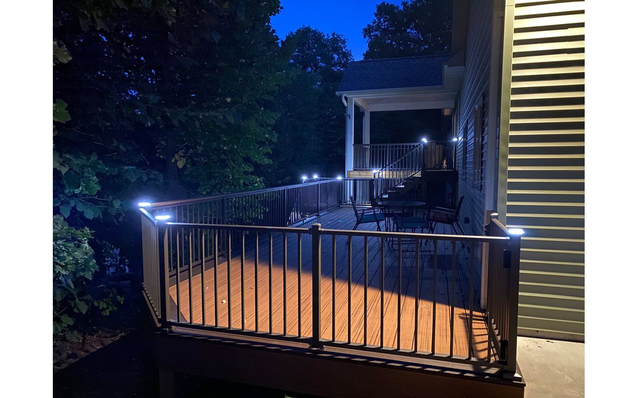 Two-Tone, Picture-Framed, Low-Maintenance Trex Transcend Composite Deck with Black, Aluminum Railing and LED Lighting for Safety and Ambiance in the Rochester, MN Area built by Schmidt Carpentry, LLC