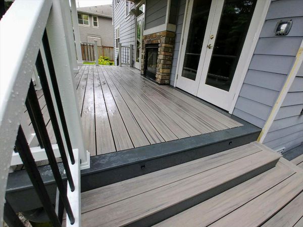 Trex Enhance Naturals Rocky Harbor decking with a Clam Shell accent with Trex Select rails and Trex LED lighting.