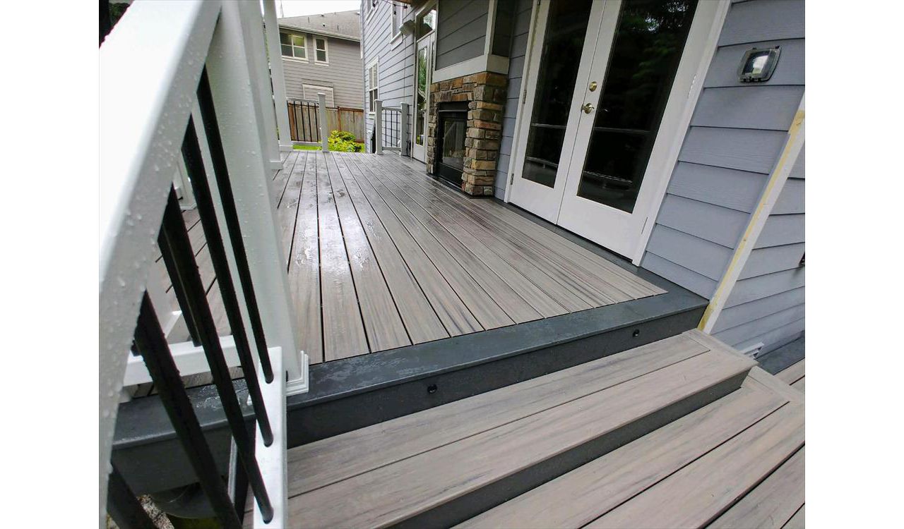 Trex Enhance Naturals Rocky Harbor decking with a Clam Shell accent with Trex Select rails and Trex LED lighting.