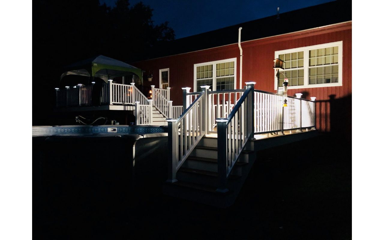 Multi level Havana Gold pool deck with lighted post caps