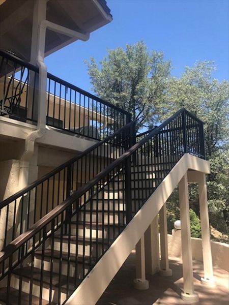 Prescott AZ. Lava Rock with groove, hidden clips.  Trex joist tape.  2x4 Lava Rock railing cap.