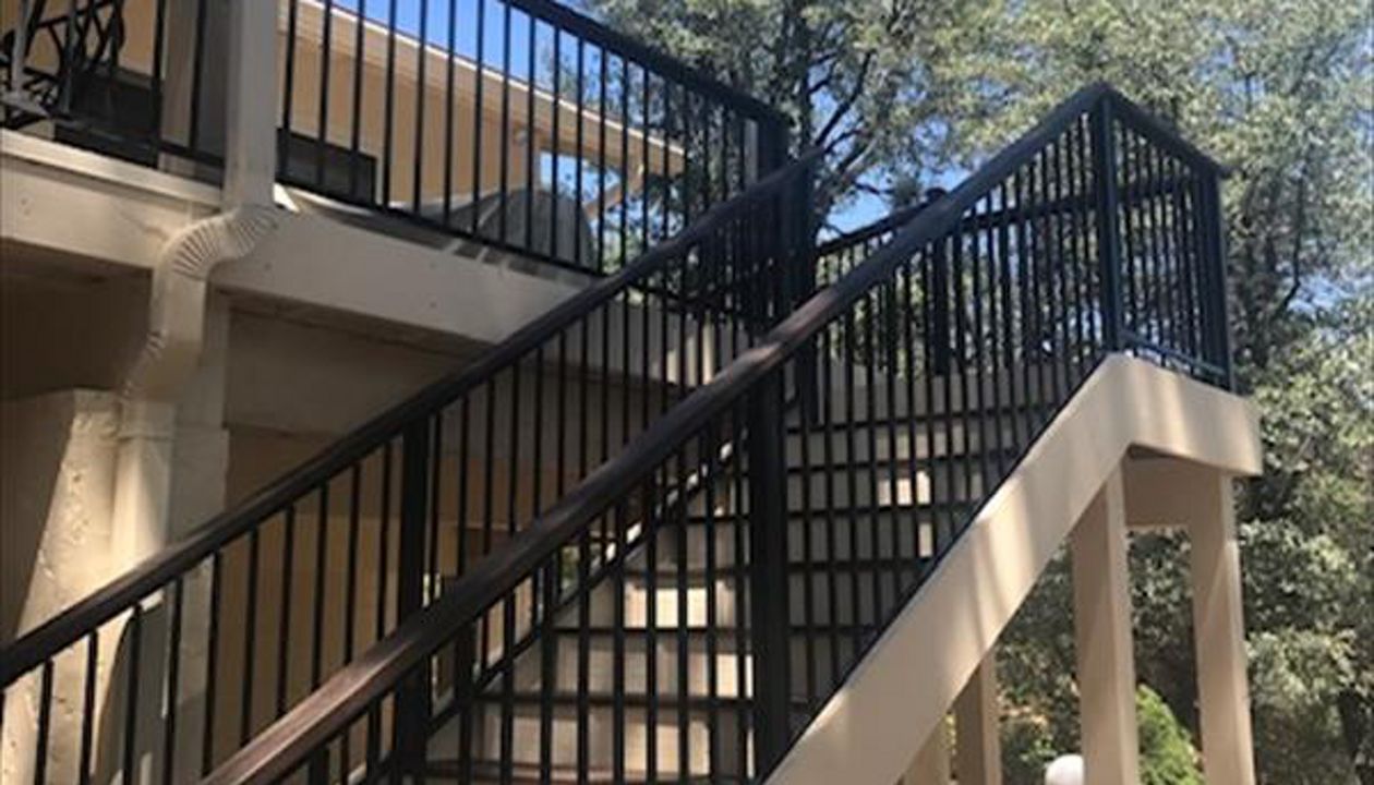 Prescott AZ. Lava Rock with groove, hidden clips.  Trex joist tape.  2x4 Lava Rock railing cap.
