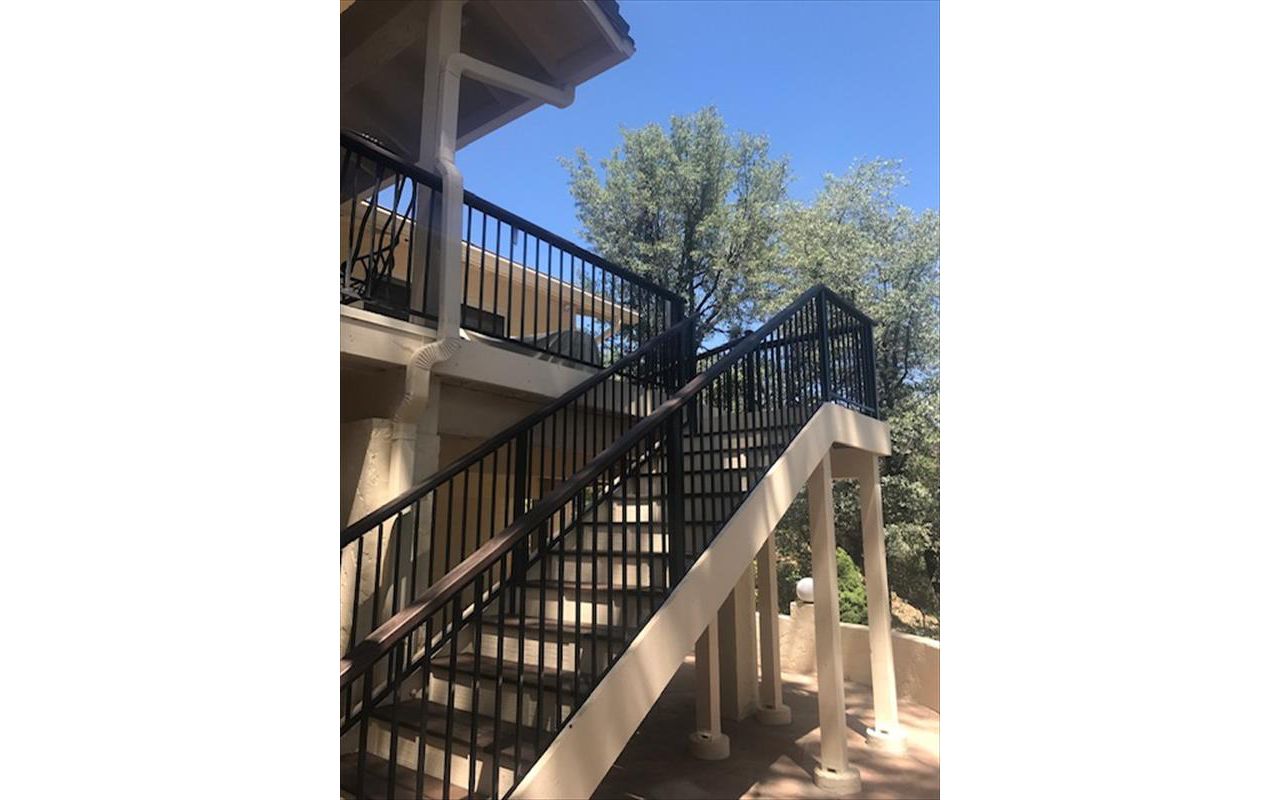 Prescott AZ. Lava Rock with groove, hidden clips.  Trex joist tape.  2x4 Lava Rock railing cap.