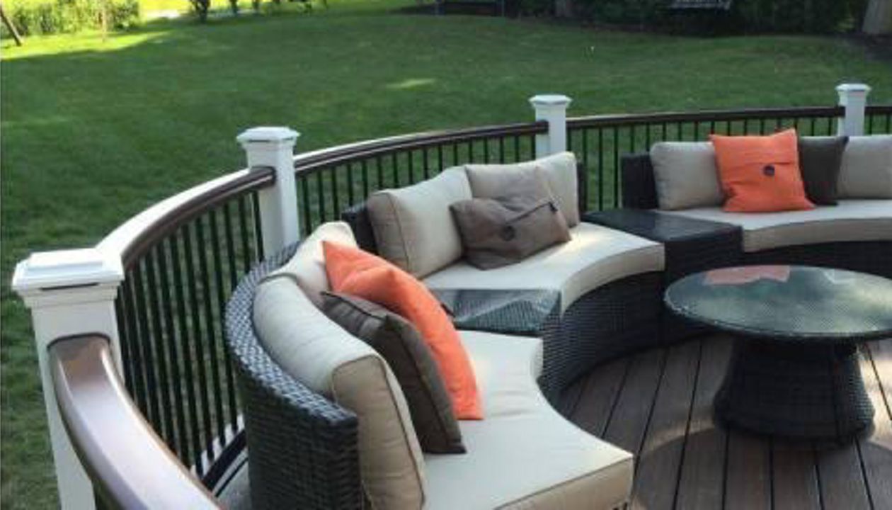 Stylish, curved deck featuring a comfortable outdoor lounging space.