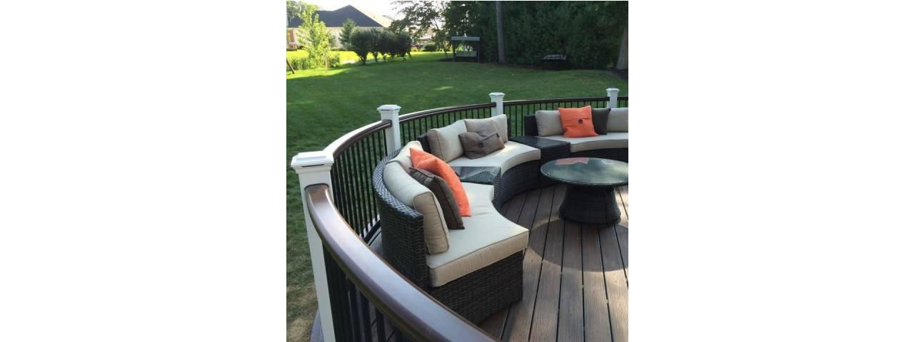 Stylish, curved deck featuring a comfortable outdoor lounging space.
