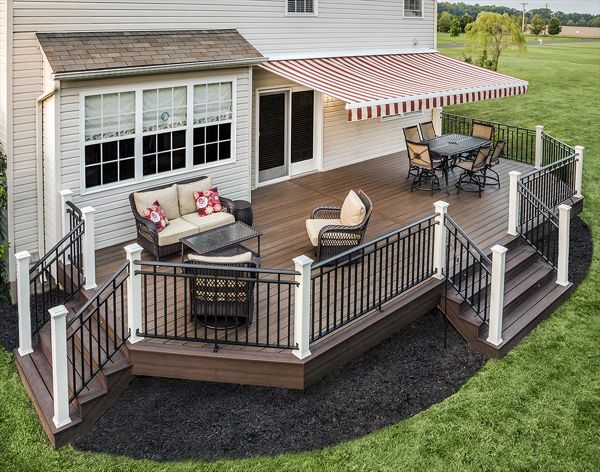 White Trex post sleeves pop nicely against the dark decking and stairs at this Kingwood, N.J., home. The posts also tie in nicely with the white in the striped retractable awning.