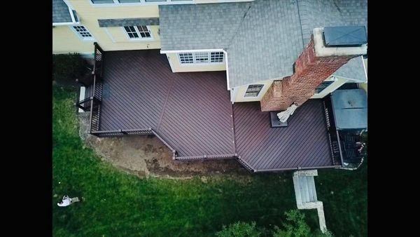 Trex Lava Rock Decking with Vintage Lantern Top/Bottom Rails and Bronze Aluminum Balusters. Custom Lattice with access gate for below deck storage. Post cap lights and riser lights in the stairs and step between tiers