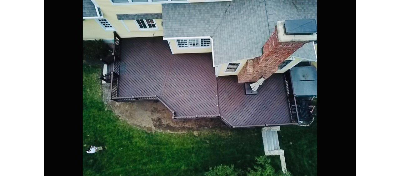 Trex Lava Rock Decking with Vintage Lantern Top/Bottom Rails and Bronze Aluminum Balusters. Custom Lattice with access gate for below deck storage. Post cap lights and riser lights in the stairs and step between tiers