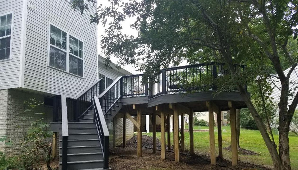 Trex Transcend Island Mist decking and matching Trex fascia. This multi level design features a custom angled staircase and Trex Transcend railings.