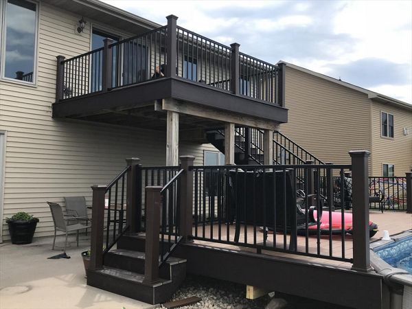 Trex Select Saddle with Woodland Brown accents and Signature black aluminum rails with lighting caps and riser lights by GE Contracting LLC