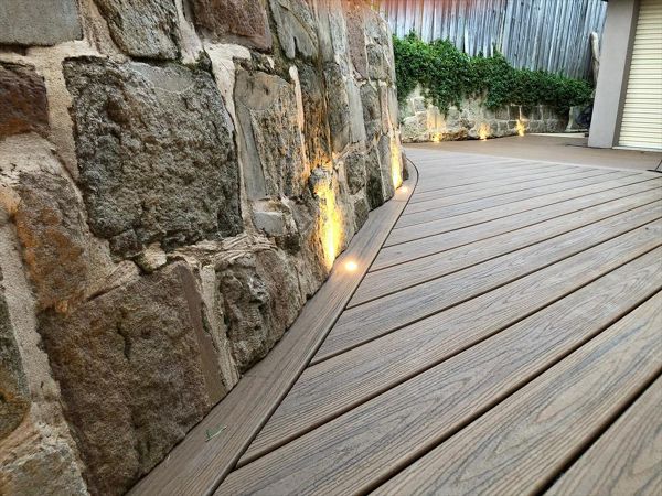 Trex Havana gold, we under cut the sandstone rock and curved the trex board under.One of the most beautiful details connecting the existing land scapes to new.