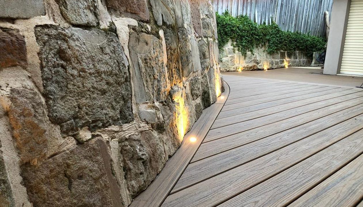 Trex Havana gold, we under cut the sandstone rock and curved the trex board under.One of the most beautiful details connecting the existing land scapes to new.