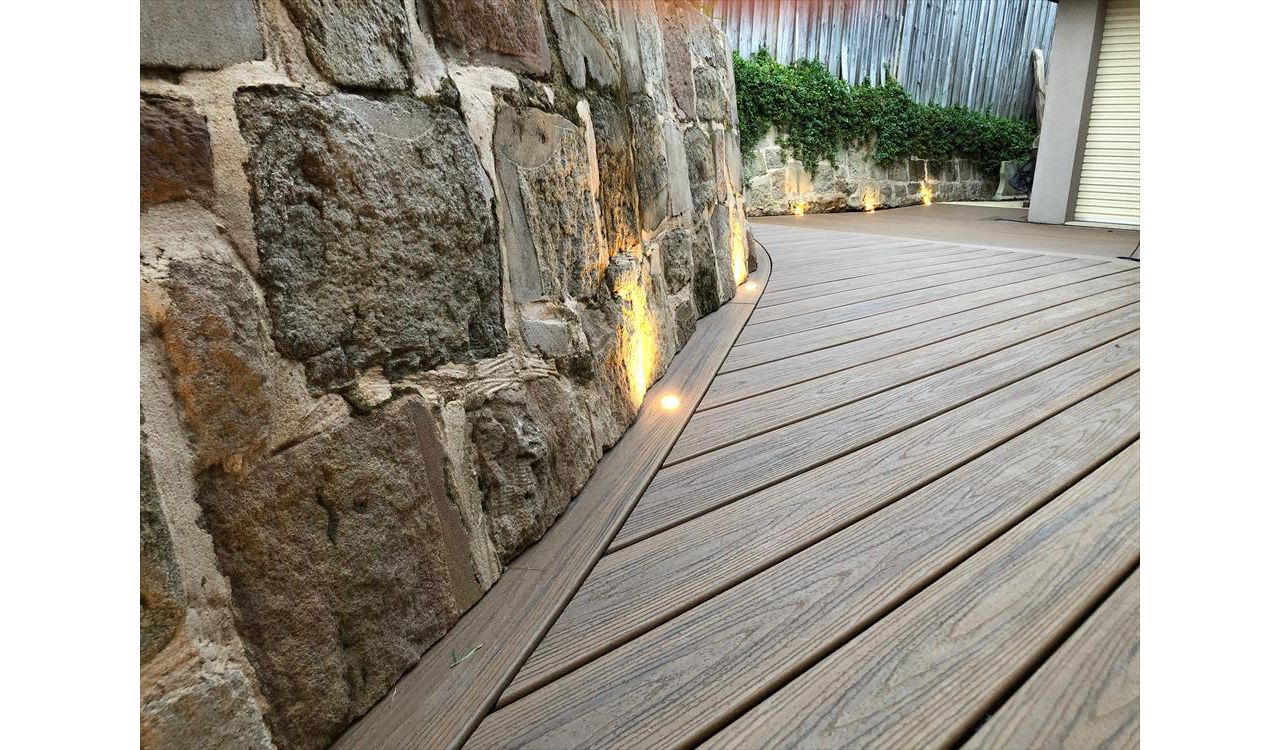 Trex Havana gold, we under cut the sandstone rock and curved the trex board under.One of the most beautiful details connecting the existing land scapes to new.