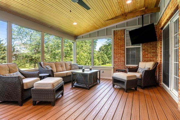 Screened in porch with decking in Trex Foggy Wharf with two Adirondack chairs looking out on the yard