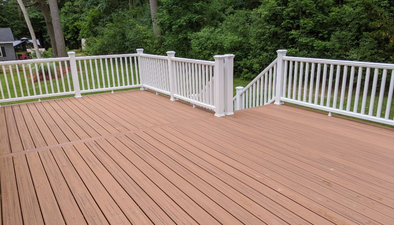 Trex Transcend "Tiki Torch" decking with white Transcend railings.