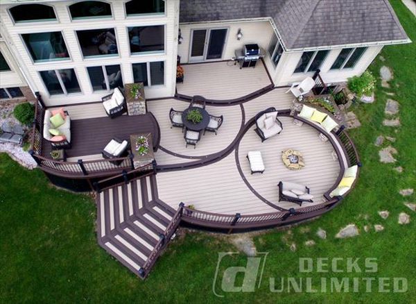 Show stopping TREX deck with all the main ingredients; curves, lighting, firepit, built in seating & planters, stone work, under deck storage, multi-levels, and flared staircase.