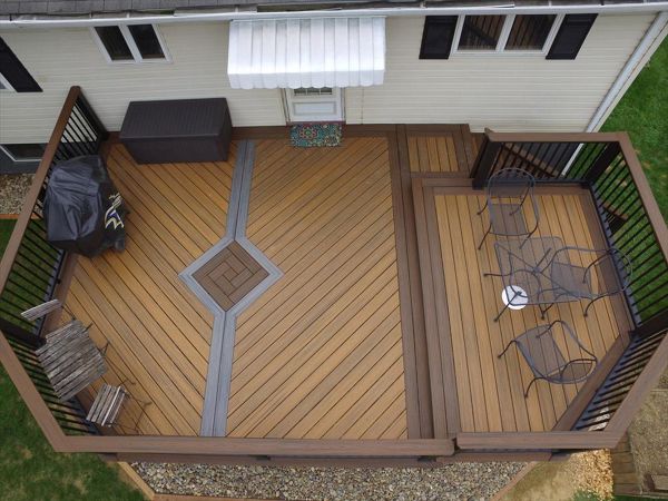 Trex Transcend deck w/ Spiced Rum, Havana Gold, and Island Mist inlay.  Finished off with square aluminum balusters and cocktail tops.