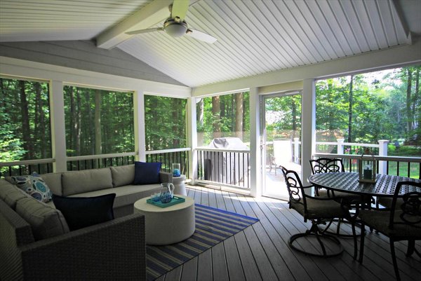 Screened in porch with decking in Trex Foggy Wharf with two Adirondack chairs looking out on the yard