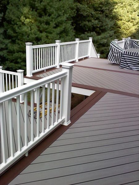 Trex Gravel Path and a Trex Fire Pit Boarder complete this hot tub deck in Shelton CT. Custom vinyl railings complete the no maintenance deck. This deck even included a Pergola