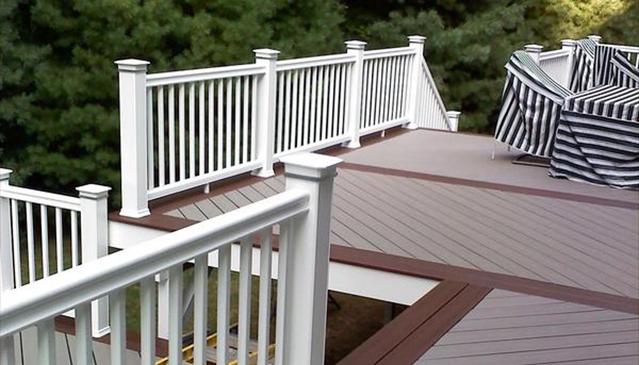 Trex Gravel Path and a Trex Fire Pit Boarder complete this hot tub deck in Shelton CT. Custom vinyl railings complete the no maintenance deck. This deck even included a Pergola