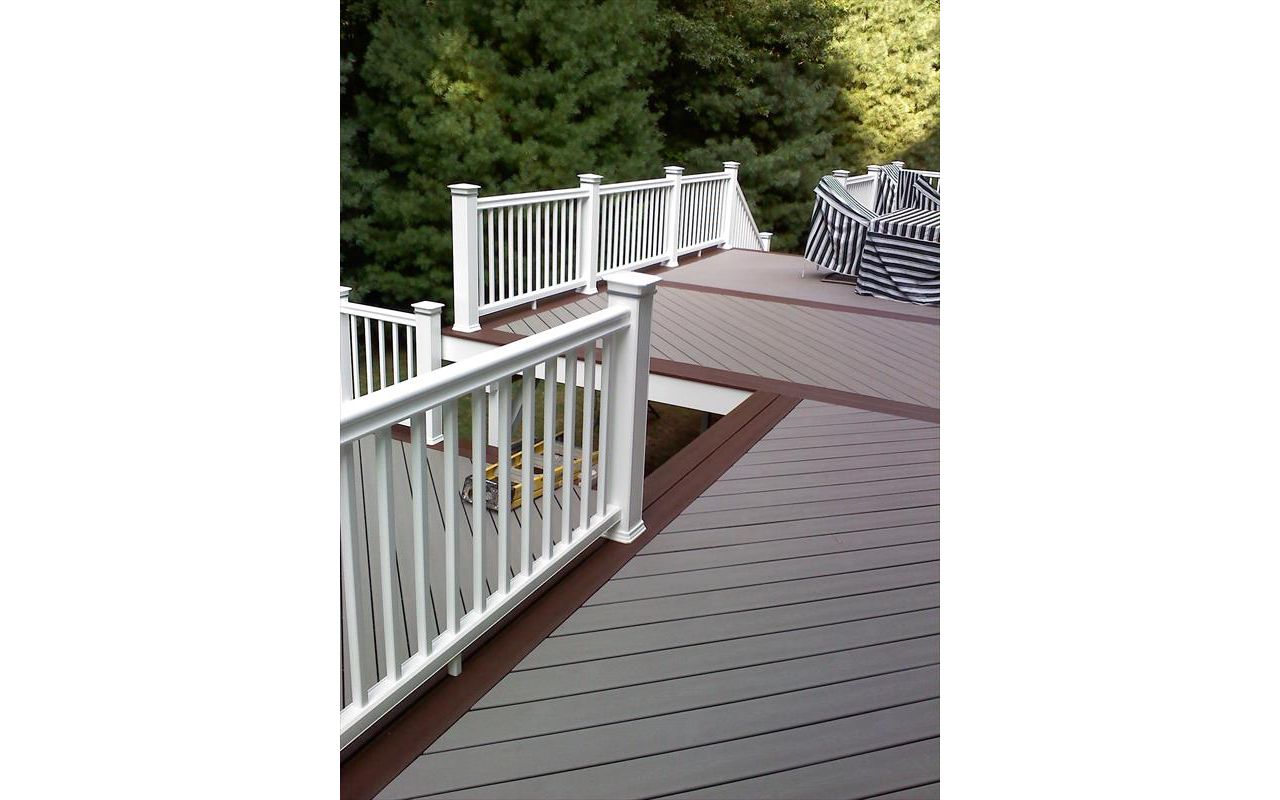 Trex Gravel Path and a Trex Fire Pit Boarder complete this hot tub deck in Shelton CT. Custom vinyl railings complete the no maintenance deck. This deck even included a Pergola