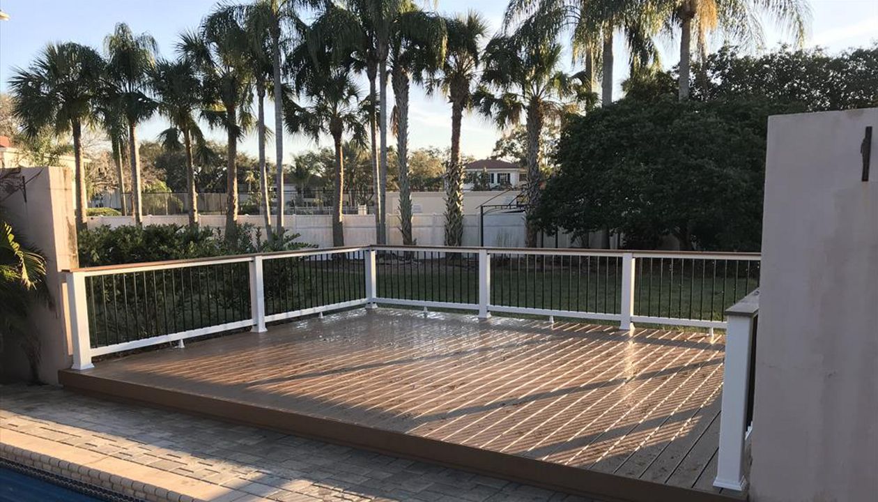 This pool deck is a nice place to dry off after a long swim. Trex Coctail railing allows for an easy transition to adult time providing the perfect place to rest that evening drink.