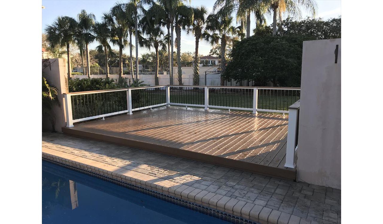 This pool deck is a nice place to dry off after a long swim. Trex Coctail railing allows for an easy transition to adult time providing the perfect place to rest that evening drink.