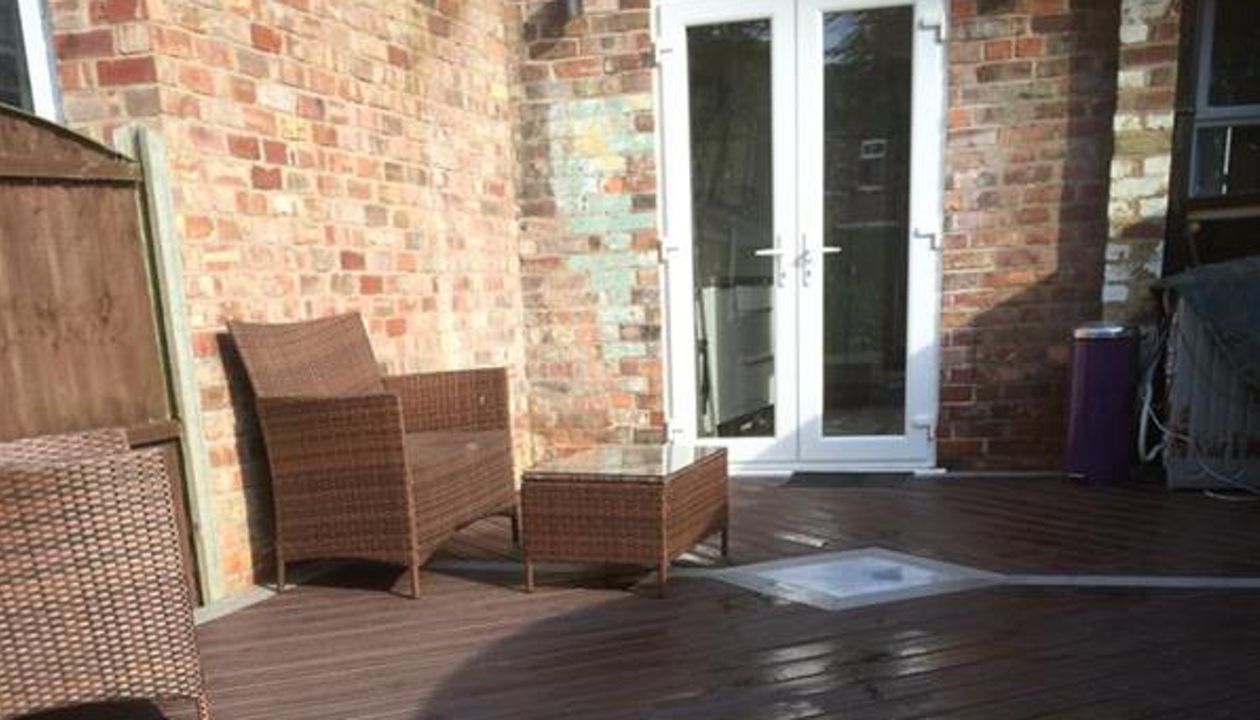 Small deck in Hale, Cheshire using Trex Transcend gravel path for the borders and Vintage lantern for the main body and skirting