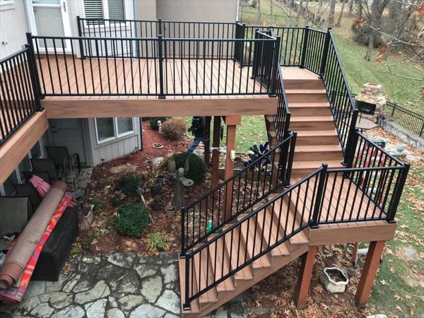 Composite deck in Warrensburg Missouri. The color of the deck is a bold tropical color called Tiki Torch.