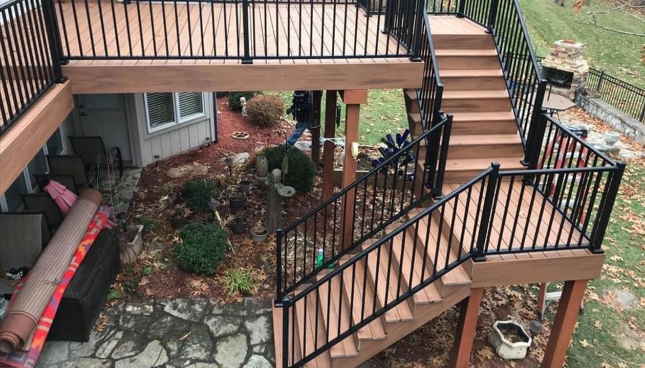 Composite deck in Warrensburg Missouri. The color of the deck is a bold tropical color called Tiki Torch.