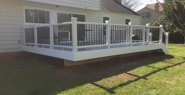 Transcend Classic White Railing. Black round aluminum balusters. TREX Select Pebble Grey decking