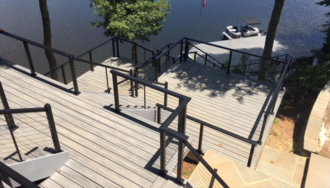 Trex deck and screened porch opens up down to a great set of stairs and a beautiful boat dock