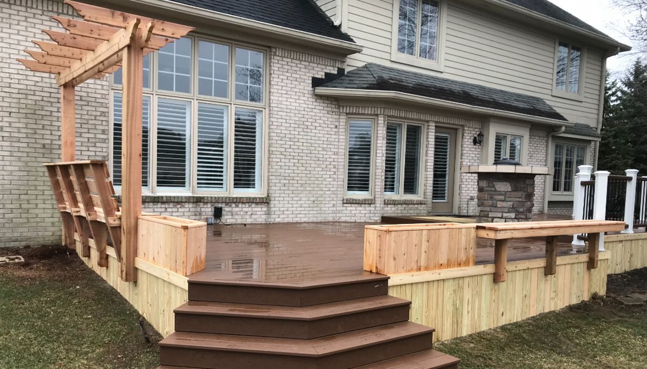 Trex Enhanced Basics (Saddle) with Treated Pine Skirting, Plantar Boxes, Trellis, Bench with Back, and Floating Bench.