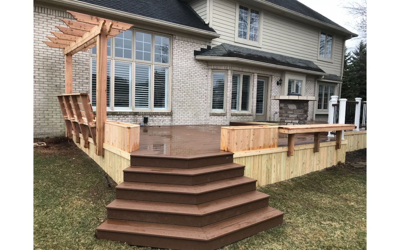 Trex Enhanced Basics (Saddle) with Treated Pine Skirting, Plantar Boxes, Trellis, Bench with Back, and Floating Bench.