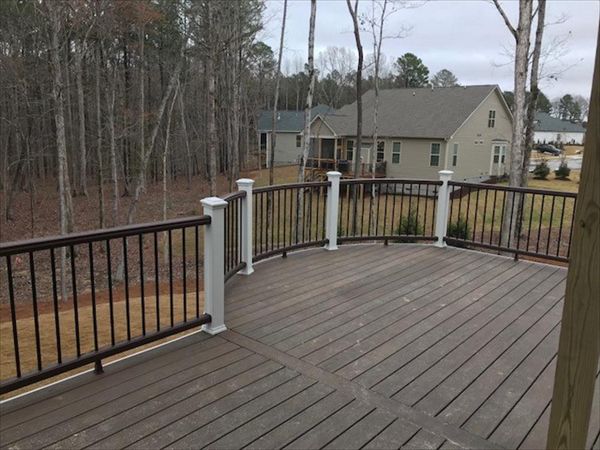 Custom Curved Trex Transcend Spiced Rum deck with Vintage Lantern railing with Classic White posts in Wake Forest, NC