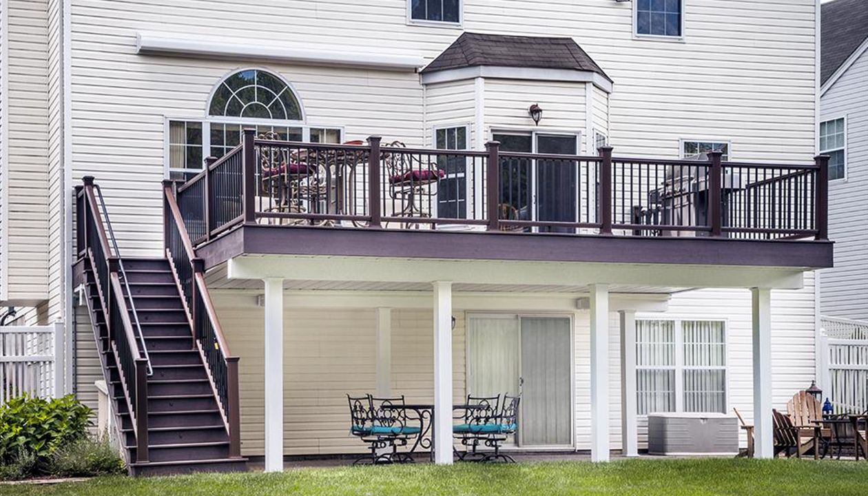 The Trex ADA-Compliant Handrail system blends seamlessly into the design of this railing system (Trex Transcend Vintage Lantern top and bottom railings with square black aluminum balusters) in Bridgewater, N.J.