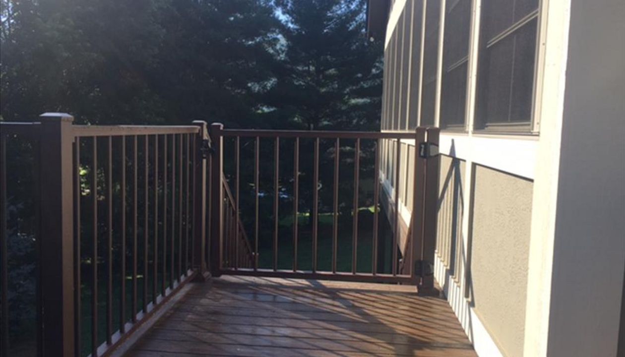 Trex Signature Bronze Aluminum Railing & gate stand up to the elements & help keep pets & kids in.