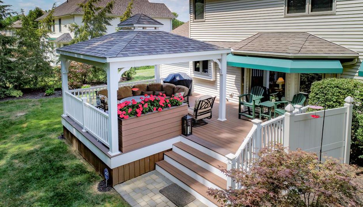 Uniontown Covered deck featuring Trex Enhance Beach dune decking with a custom planter box and vertical skirting