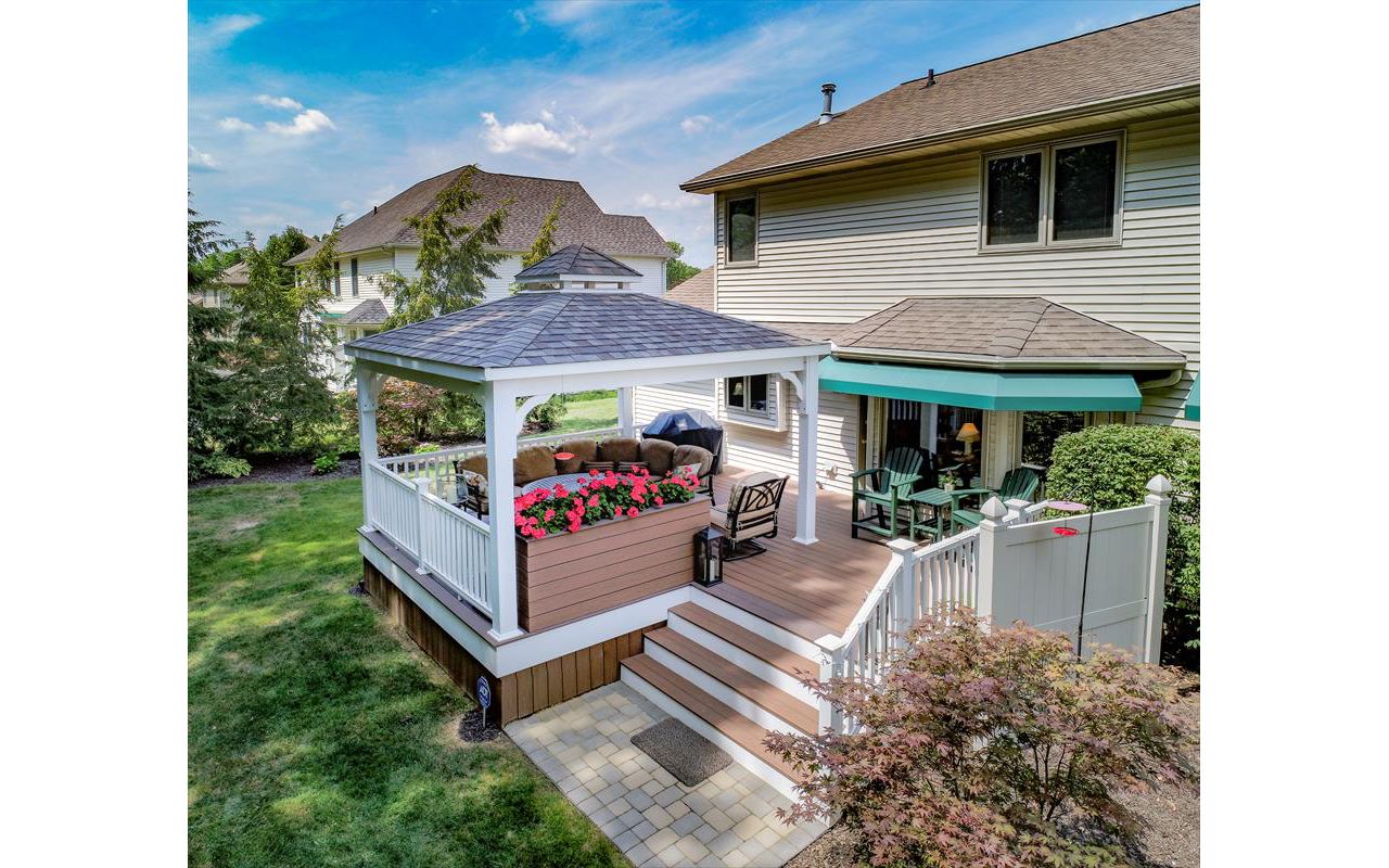 Uniontown Covered deck featuring Trex Enhance Beach dune decking with a custom planter box and vertical skirting