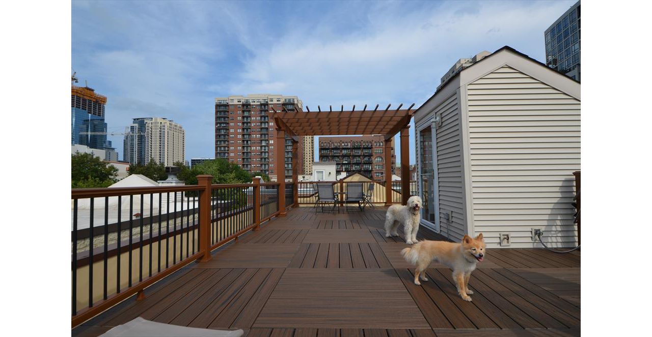 Trex Transcend Spiced Rum Decking with Tree House Railings, Black Aluminum Balusters,and a Pergola - Chicago, IL