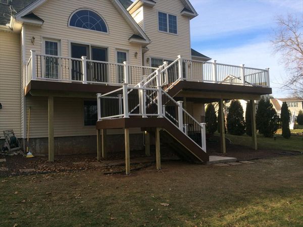select Saddle decking, risers and fascia. Vinyl rail with black pipe balusters