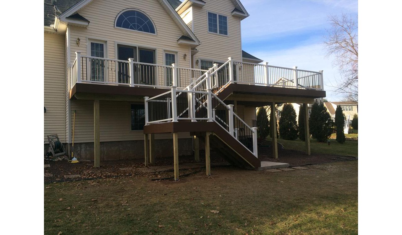 select Saddle decking, risers and fascia. Vinyl rail with black pipe balusters