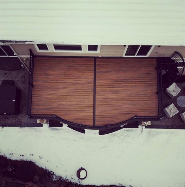 Centennial, CO Trex Deck featuring curved Trex Tiki Torch Decking with Trex Lava Rock border